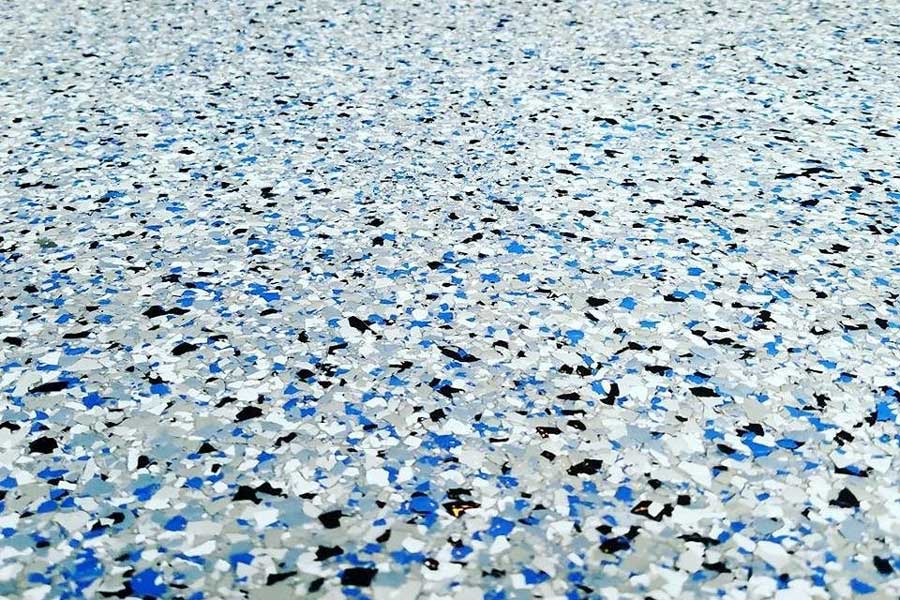 Close up detail or resin flake flooring installed at industrial premises in Hertfordshire